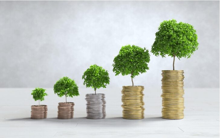Five stacks of coins of increasing height, each with a small tree growing from the top